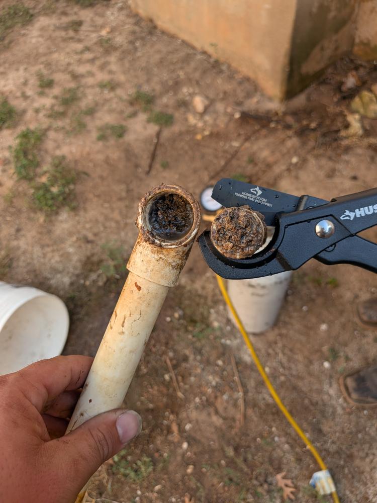 Condensate drain pipe with visible internal buildup