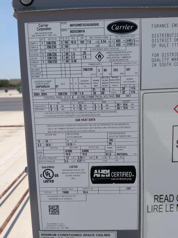Carrier rooftop HVAC unit data plate in North Austin