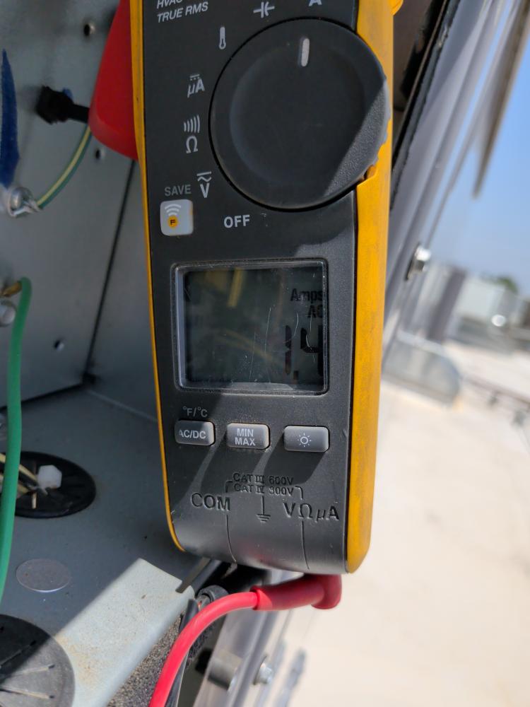 Clamp meter testing commercial HVAC wiring compartment