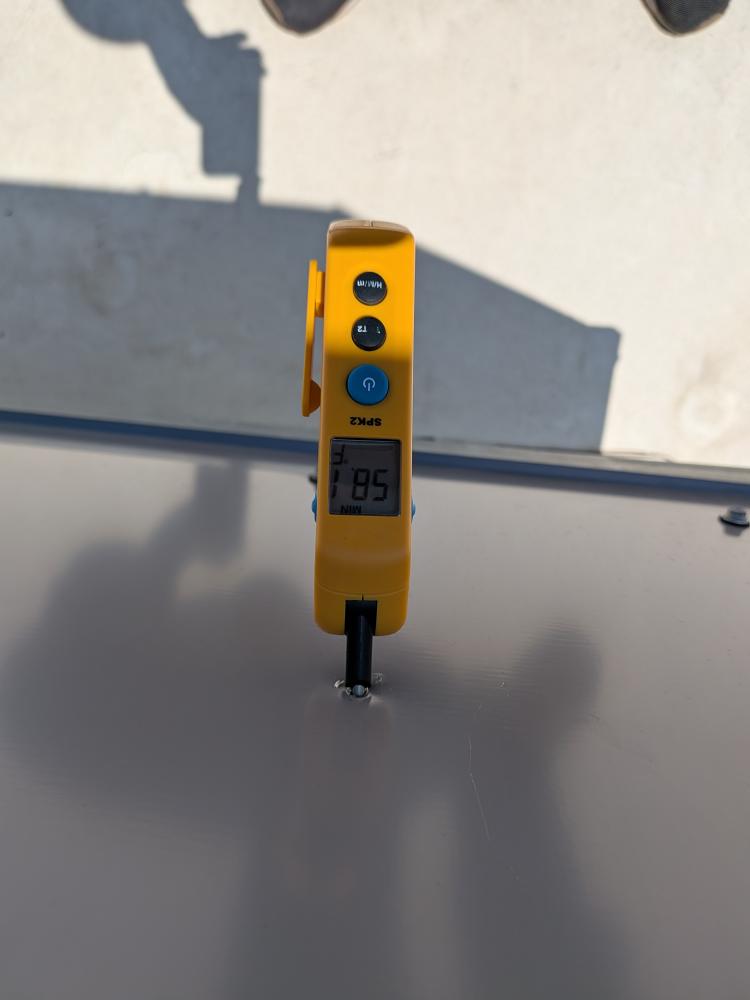 Handheld temperature probe on North Austin rooftop unit