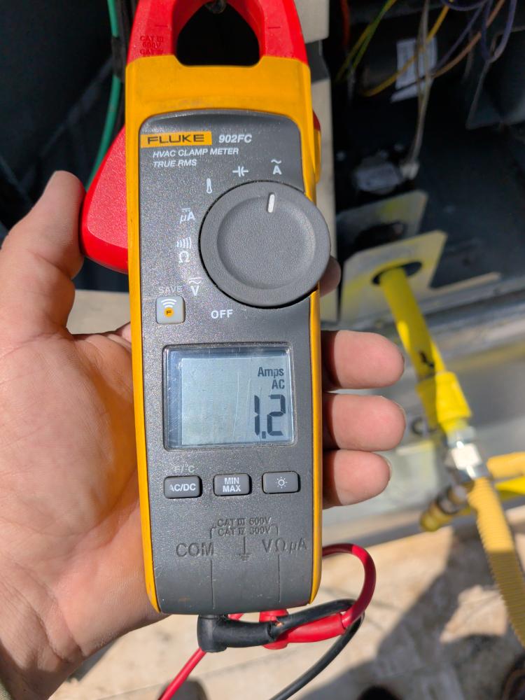 Clamp meter showing electrical reading on Carrier rooftop unit