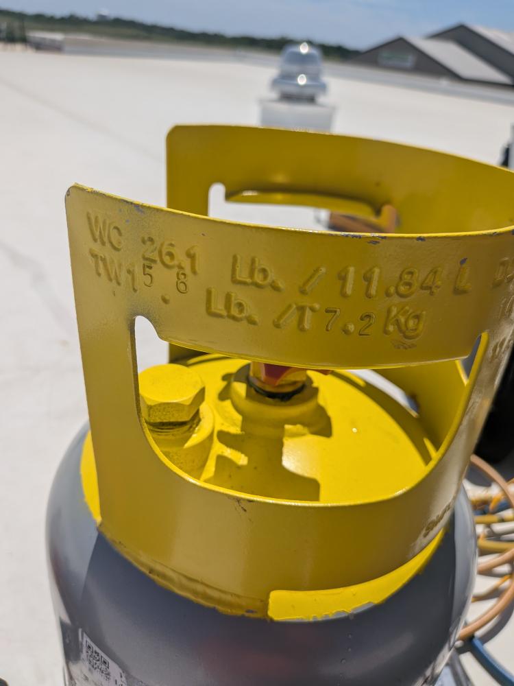 Labeled refrigerant cylinder used during rooftop HVAC testing