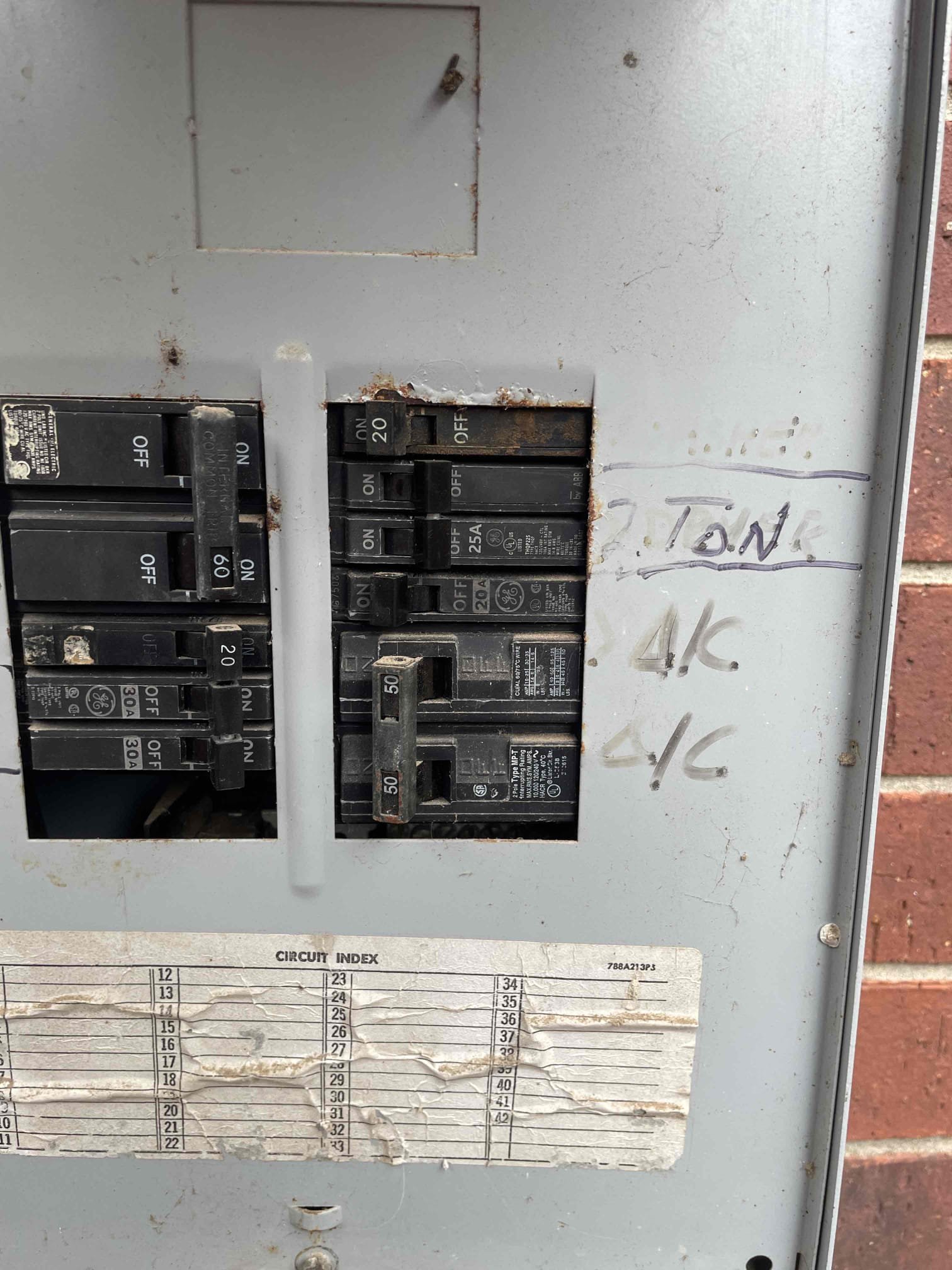 Electrical breaker panel documented during residential AC service